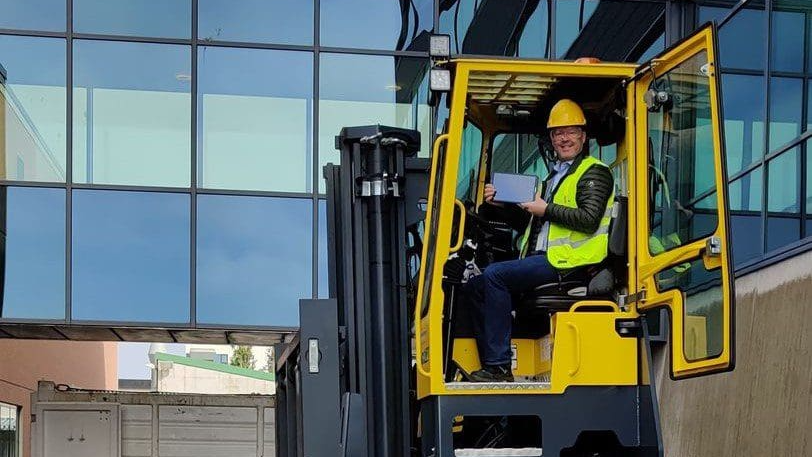 Forklift operator using a tablet in an industrial yard with EZYardService